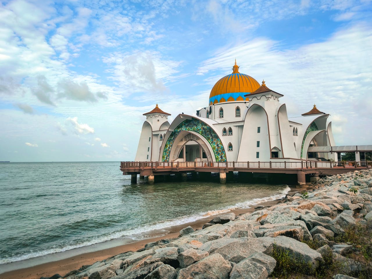 about-01 Breathtaking architecture of the Melaka Straits Mosque against the serene sea and sky.